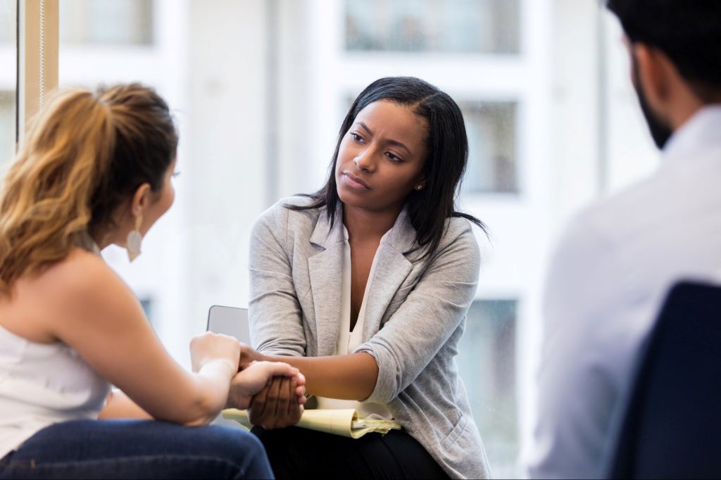 Manager leading a diverse team meeting with empathy and compassion in the workplace