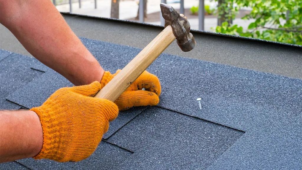 Close-up of a shingling hammer on a roof, demonstrating its use for installing shingles