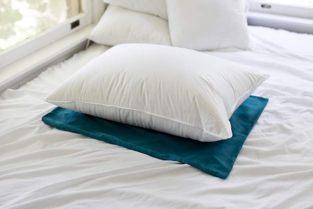 Close-up of fluffy Puredown goose down pillow on luxury hotel bed with white linens